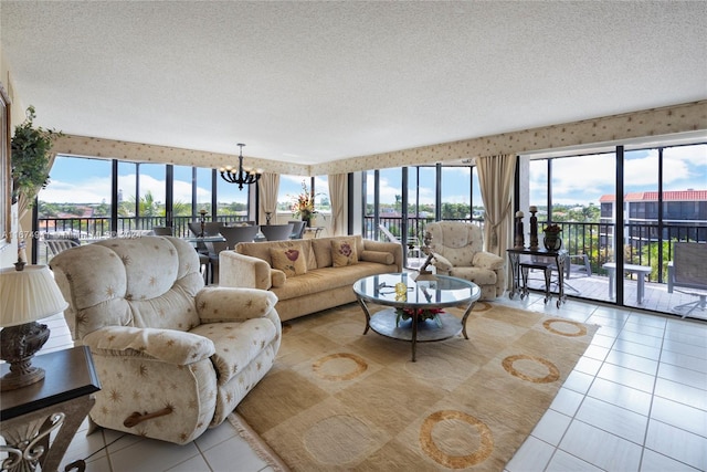 tiled living room with a wealth of natural light, a notable chandelier, and a textured ceiling