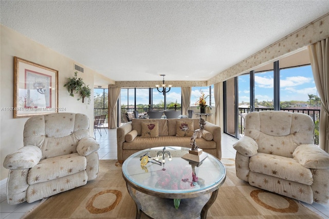 tiled living room with a notable chandelier and a textured ceiling