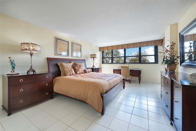 bedroom featuring a textured ceiling and light tile patterned flooring