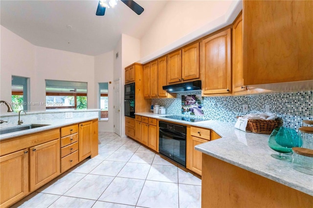 kitchen with sink, backsplash, light tile patterned floors, black appliances, and light stone countertops