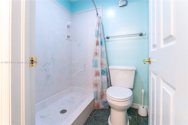 bathroom featuring tile patterned floors, toilet, and curtained shower