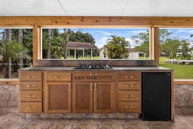 kitchen with fridge and black gas cooktop