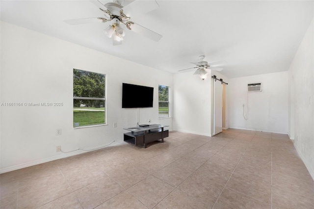 unfurnished living room featuring light tile patterned flooring, ceiling fan, and a wall unit AC