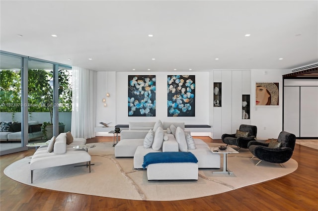 living room with light wood-type flooring and a wall of windows