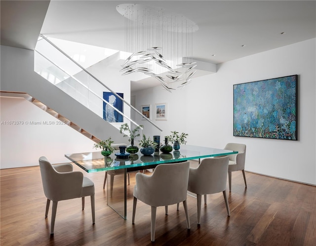 dining room with stairway and wood finished floors