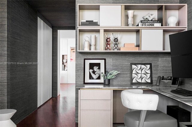 office area featuring dark hardwood / wood-style flooring and built in desk