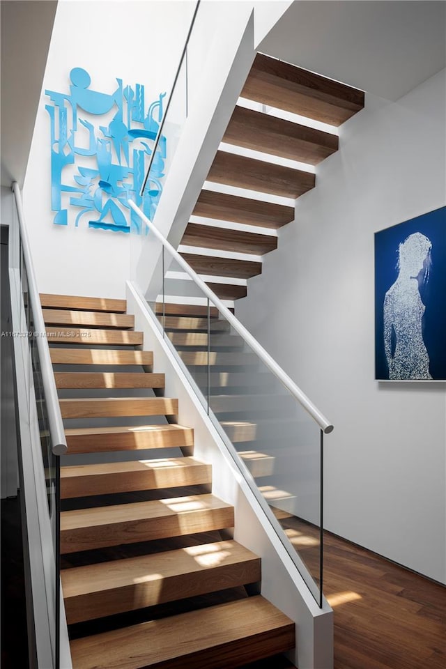 staircase featuring hardwood / wood-style floors