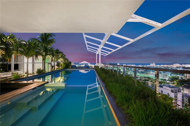 view of pool at dusk