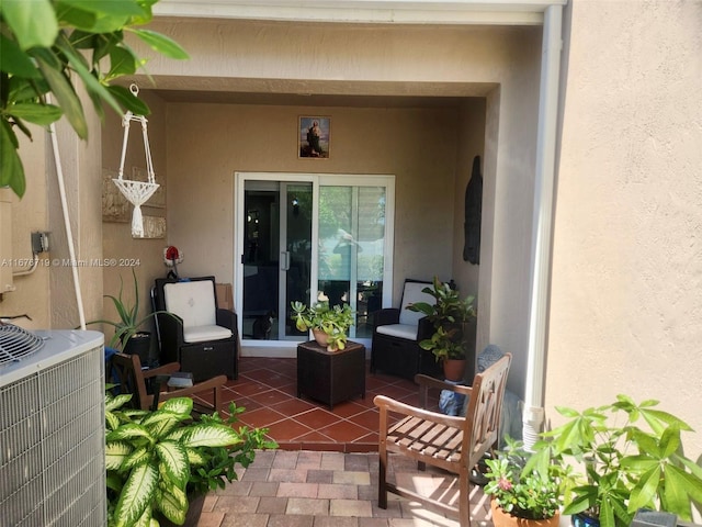 entrance to property featuring a patio and central AC unit