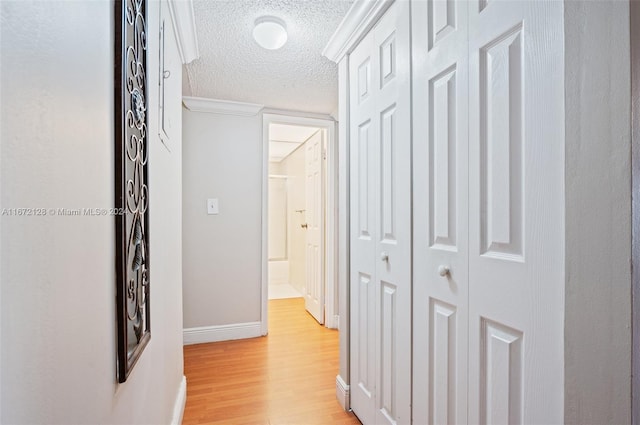 hallway featuring a textured ceiling and light wood-type flooring