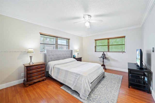 bedroom featuring ornamental molding, hardwood / wood-style floors, a textured ceiling, and ceiling fan