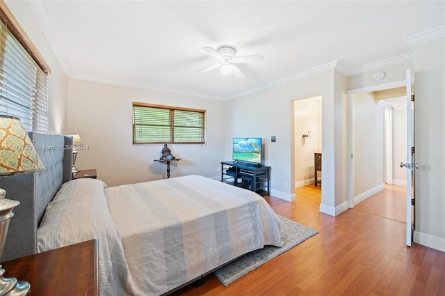 bedroom featuring ornamental molding, wood-type flooring, and ceiling fan