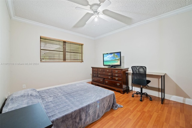 bedroom featuring ceiling fan, hardwood / wood-style flooring, a textured ceiling, and ornamental molding