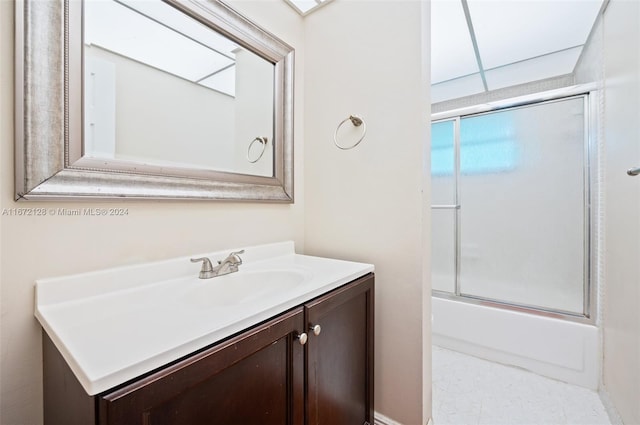 bathroom with vanity and shower / bath combination with glass door