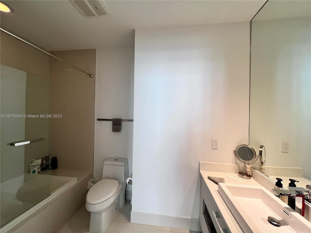 full bathroom featuring vanity, tiled shower / bath combo, toilet, and tile patterned floors