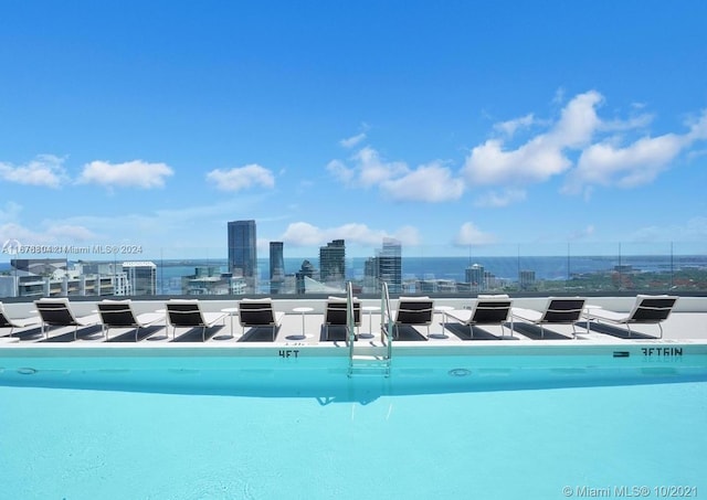 view of swimming pool with a water view