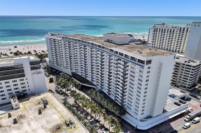 aerial view with a water view and a beach view