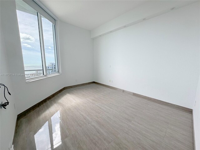 325 S Biscayne Blvd Unit 19, Miami, FL 33131 - spare room featuring baseboards