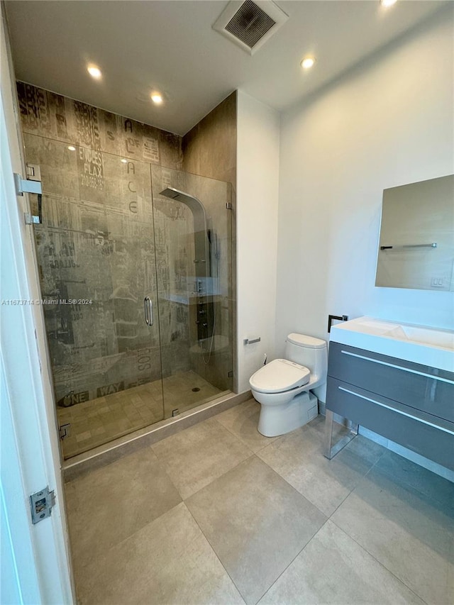 bathroom with vanity, toilet, and walk in shower