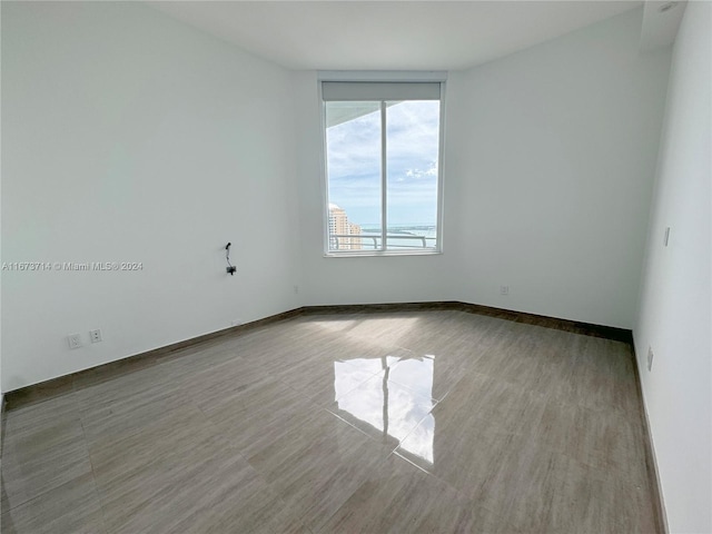 unfurnished room with wood-type flooring