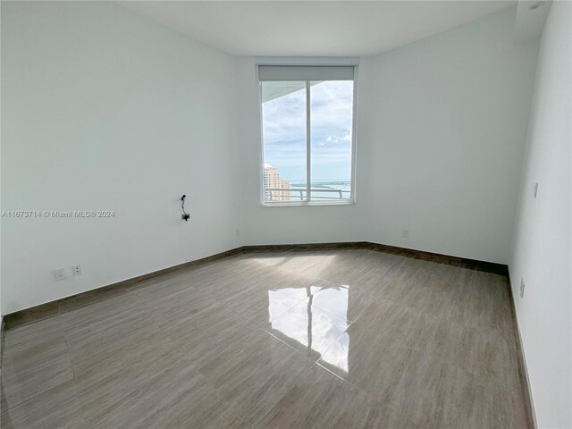 325 S Biscayne Blvd Unit 19, Miami, FL 33131 - spare room with baseboards and wood finished floors