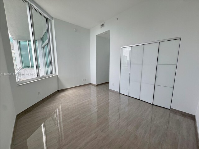 325 S Biscayne Blvd Unit 19, Miami, FL 33131 - unfurnished bedroom with a closet and baseboards