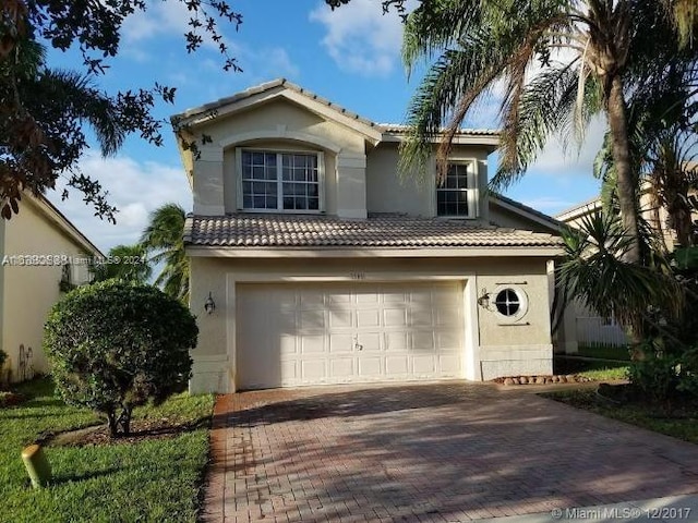 mediterranean / spanish house with a garage