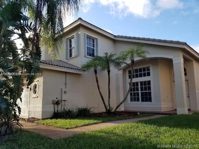 view of property exterior with a lawn