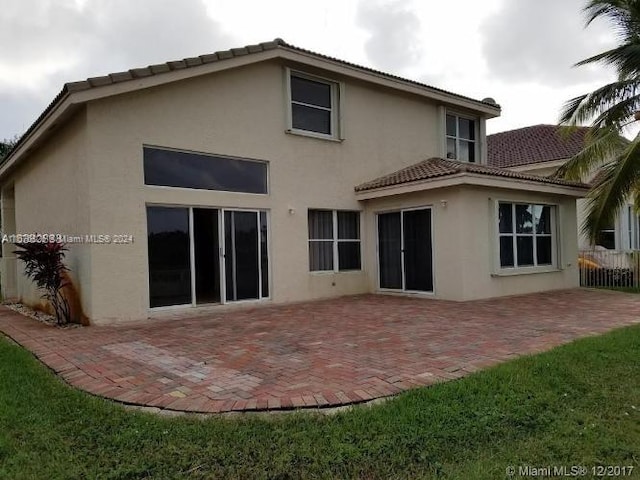 back of property featuring a patio area