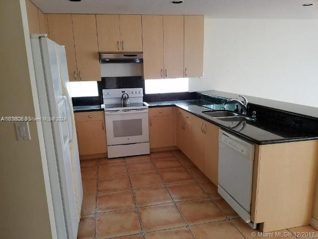 kitchen with white appliances, sink, and light brown cabinets