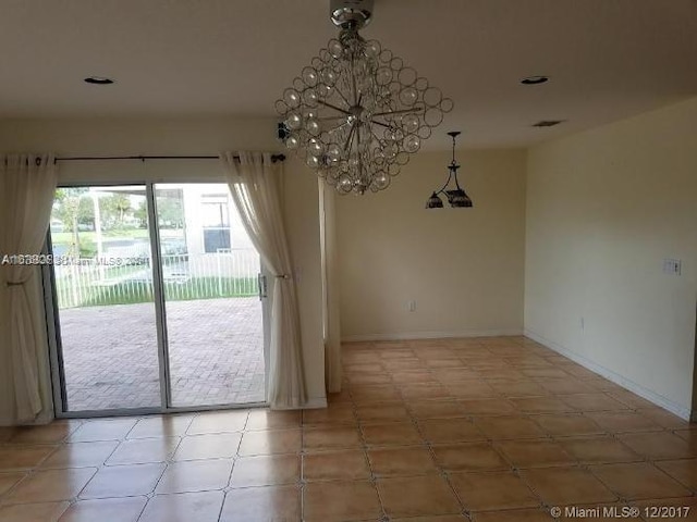 unfurnished dining area featuring a notable chandelier