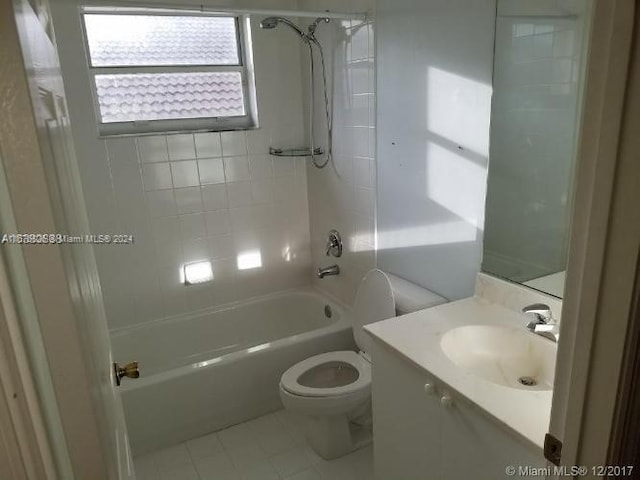 full bathroom with vanity, tiled shower / bath combo, toilet, and tile patterned flooring