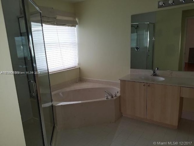 bathroom featuring vanity, plus walk in shower, and tile patterned floors