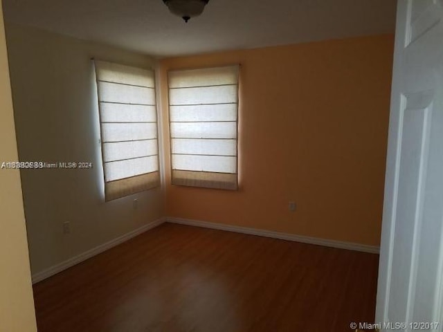 unfurnished room with hardwood / wood-style flooring