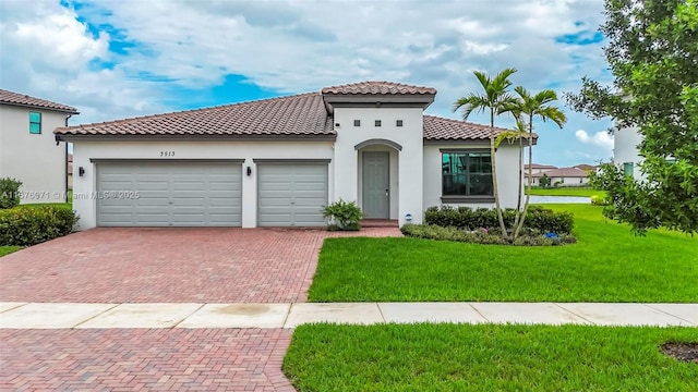 mediterranean / spanish house with a garage and a front lawn