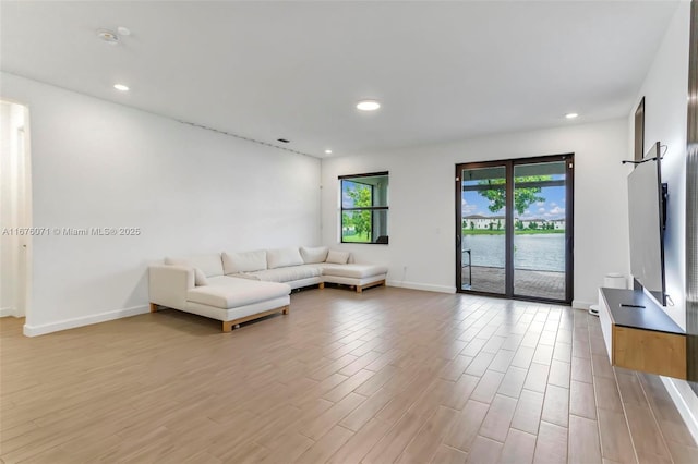 unfurnished living room featuring a water view