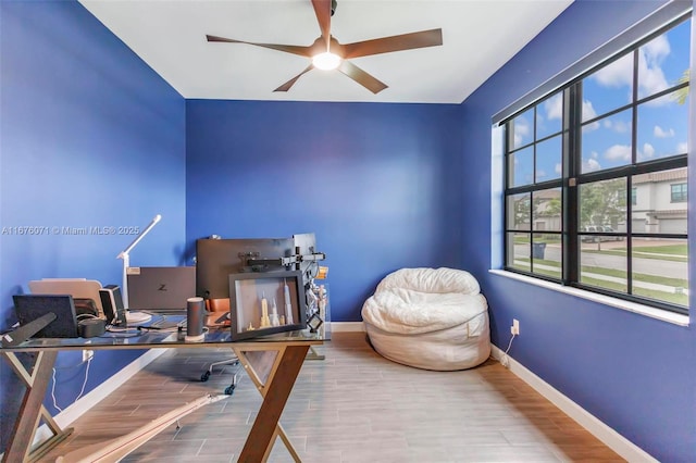 office space with ceiling fan, plenty of natural light, and hardwood / wood-style floors