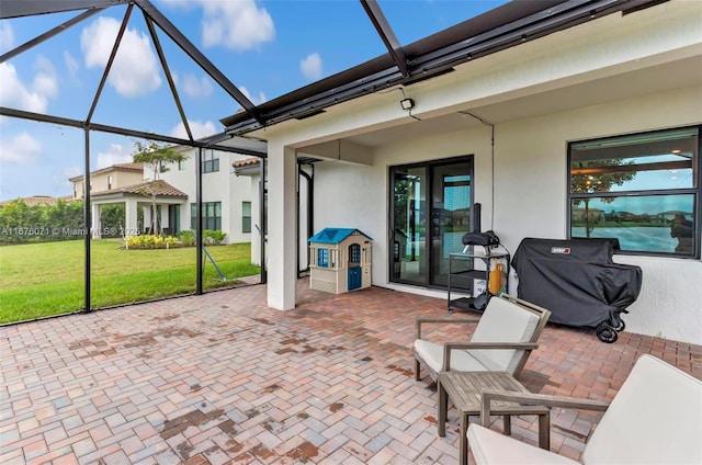 view of patio / terrace featuring a lanai and grilling area