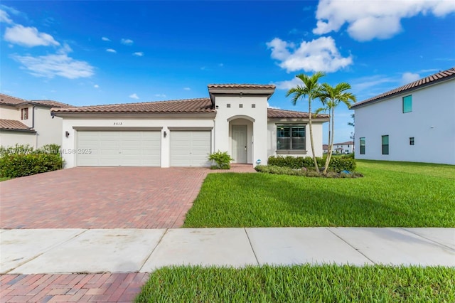 mediterranean / spanish-style home featuring a garage and a front lawn