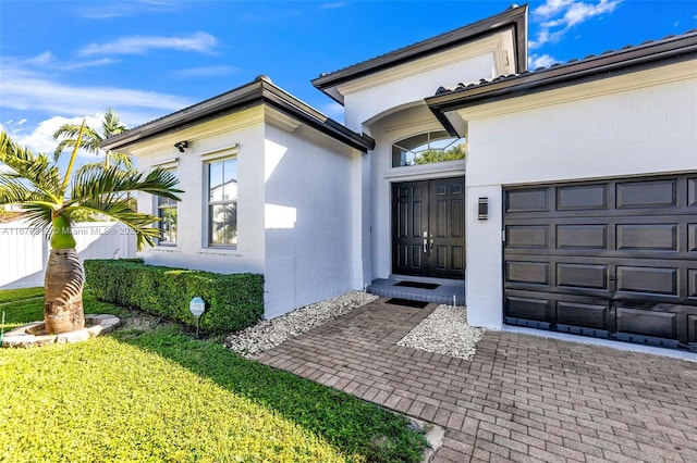 entrance to property with a lawn