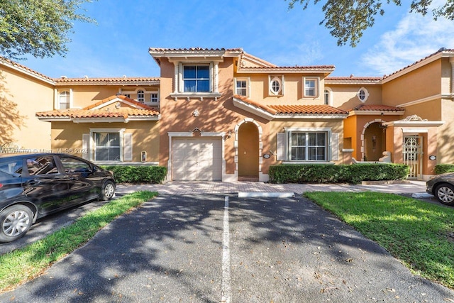 mediterranean / spanish-style house with a garage