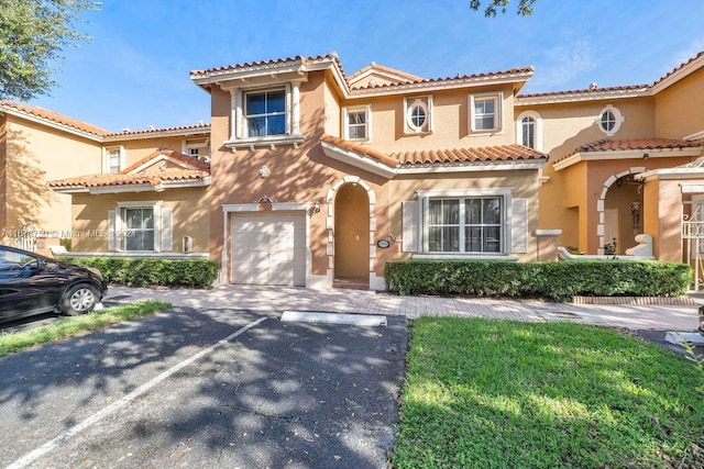 mediterranean / spanish-style house with a garage