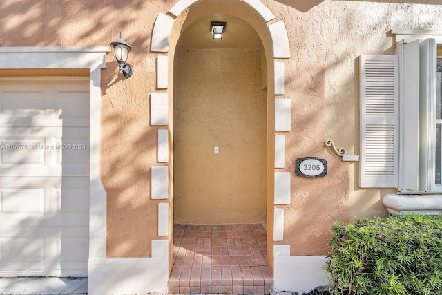 view of exterior entry with a garage