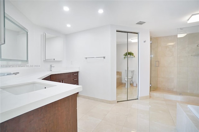 full bathroom featuring vanity, toilet, independent shower and bath, and tile patterned flooring