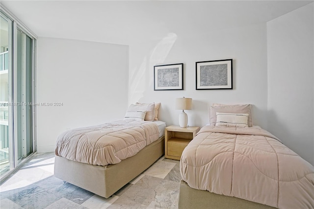 bedroom featuring a wall of windows and access to outside