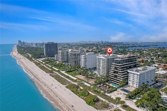 bird's eye view with a water view and a beach view