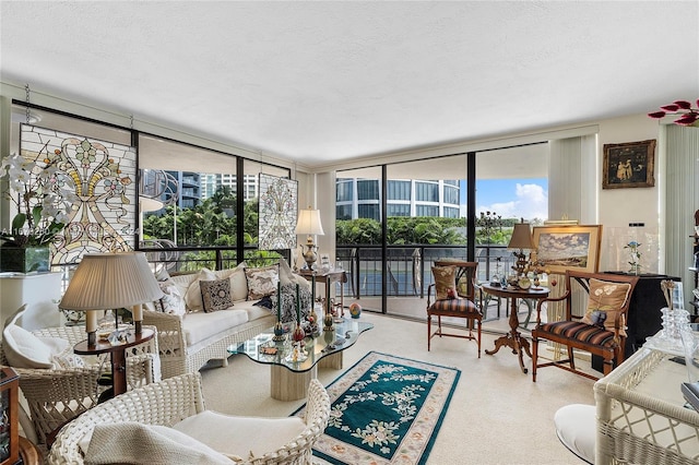 living room with a textured ceiling, a wealth of natural light, and floor to ceiling windows