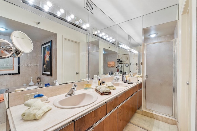 bathroom with vanity, tile patterned flooring, and a shower with door