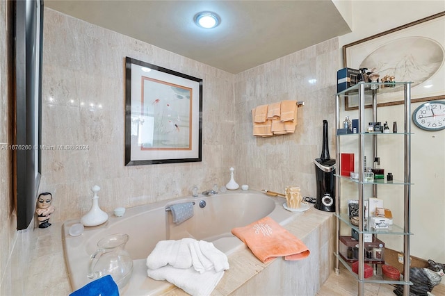 bathroom with tiled tub and tile walls