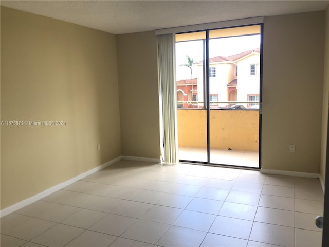 empty room featuring baseboards and a textured ceiling